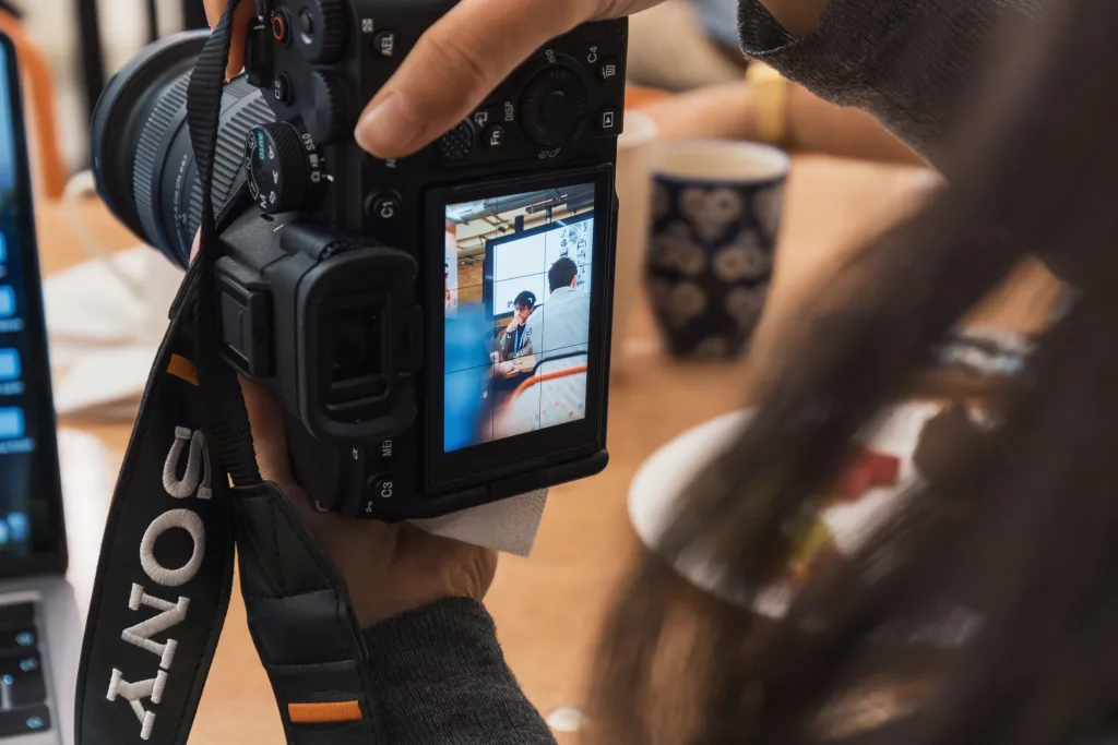 Photographer reviewing a portrait on the rear screen of a Sony mirrorless camera
