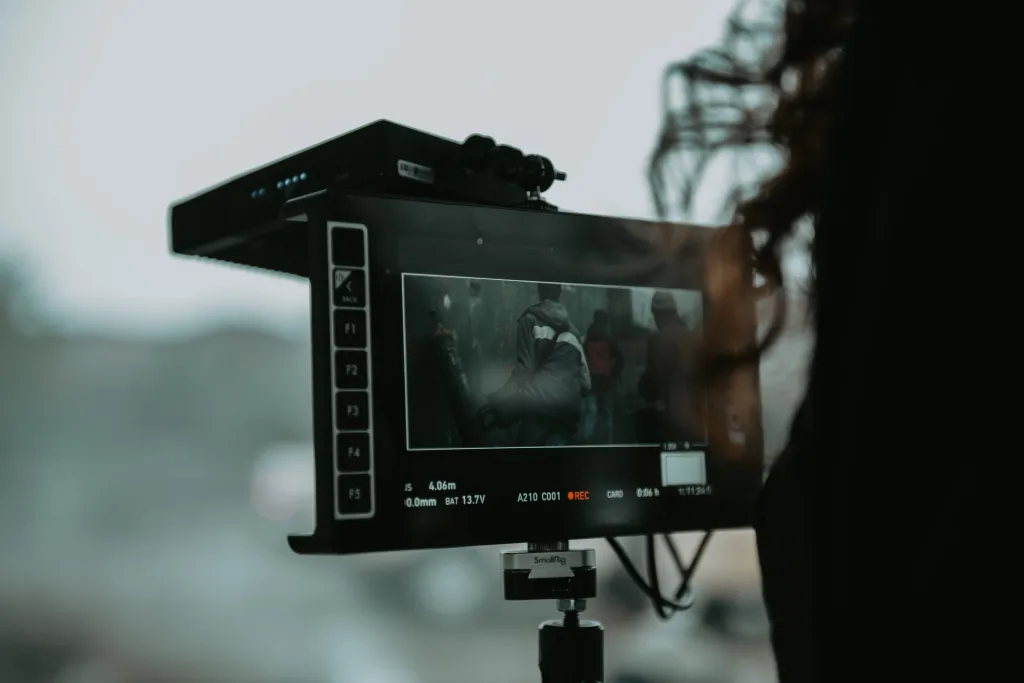 Production monitor displaying live footage while recording on an outdoor film set